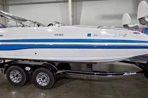 The Image of 2019 Hurricane SunDeck Sport 201 OB boat on trailer in indoor setting. - 0