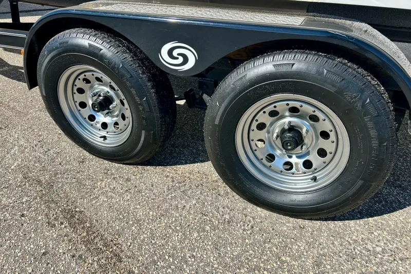 Slide: The Image of Trailer wheels of a 2019 Hurricane SunDeck Sport 201 OB on asphalt. - 16