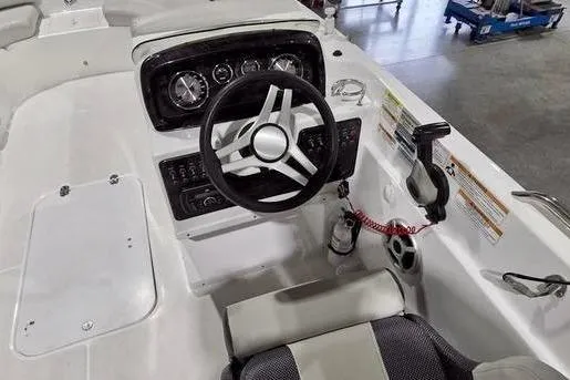 Slide: The Image of 2019 Hurricane SunDeck Sport 201 OB boat cockpit with steering wheel and control panel. - 2