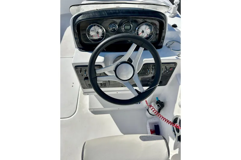 Slide: The Image of 2019 Hurricane SunDeck Sport 201 OB boat dashboard with steering wheel and gauges. - 40