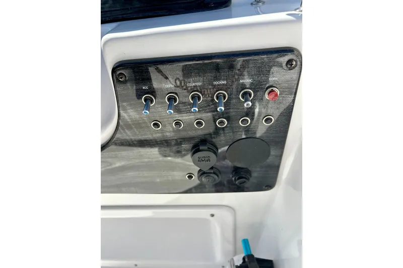 Slide: The Image of Control panel of 2019 Hurricane SunDeck Sport 201 OB boat with switches and ports. - 42