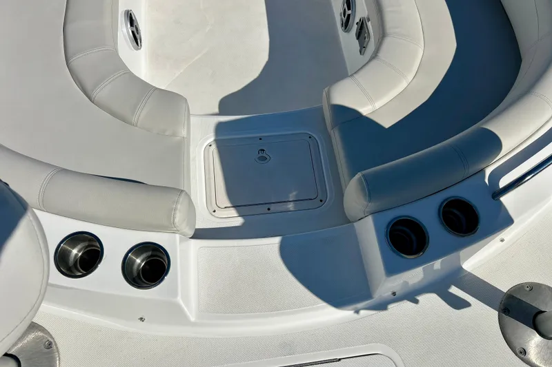 Slide: The Image of 2019 Hurricane SunDeck Sport 201 OB boat interior with cushioned seating and cup holders. - 58