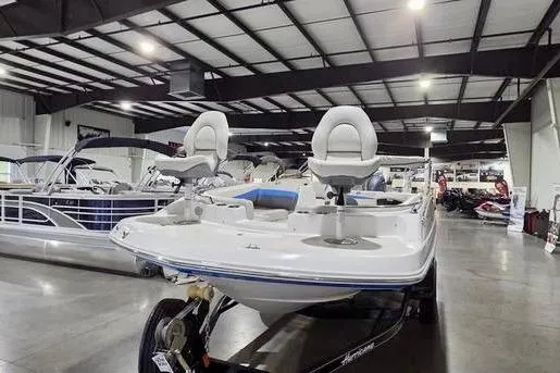 Slide: The Image of 2019 Hurricane SunDeck Sport 201 OB boat displayed in a showroom with sleek design. - 6