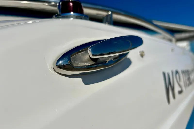 Slide: The Image of Close-up of a 2019 Hurricane SunDeck Sport 201 OB boat's chrome cleat against a clear blue sky. - 63