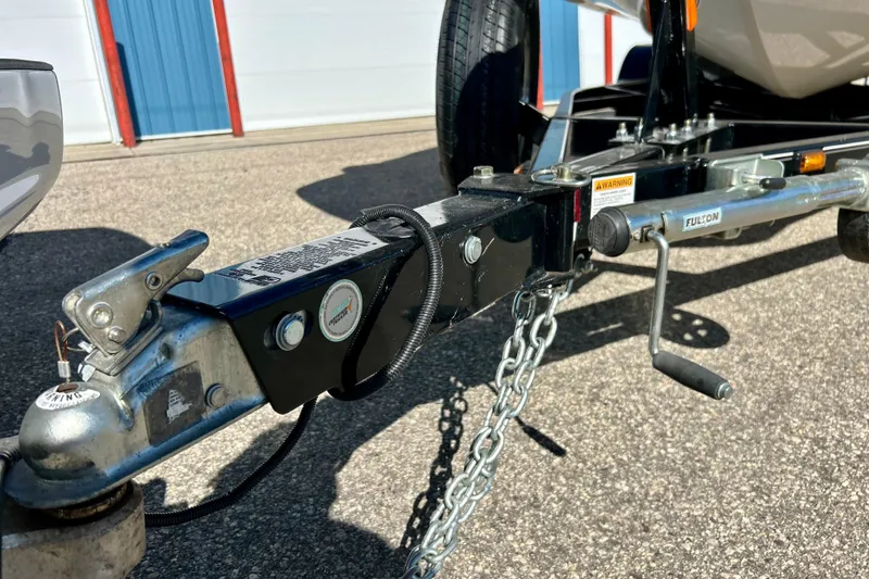 Slide: The Image of Trailer hitch of 2019 Hurricane SunDeck Sport 201 OB boat on pavement. - 64