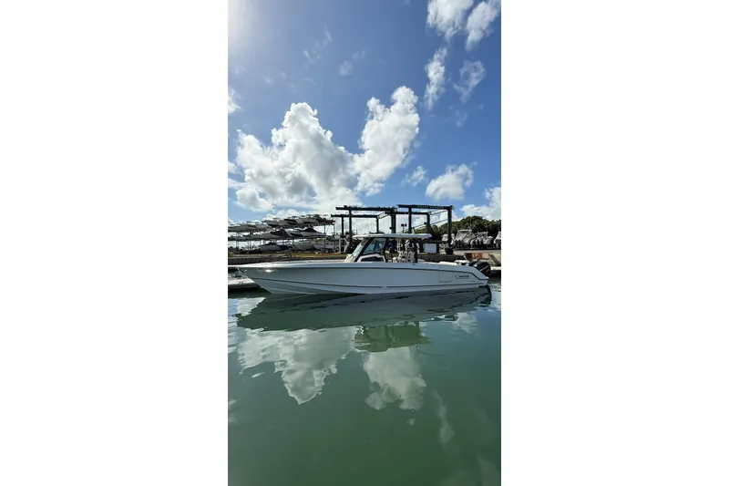 The Image of 2022 Boston Whaler 380 Outrage boat docked under a clear blue sky. - 1