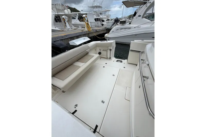 Slide: The Image of 2022 Boston Whaler 380 Outrage boat interior with seating, docked at marina. - 6