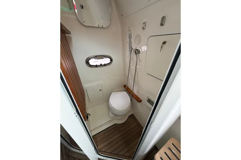 Slide: The Image of 2022 Boston Whaler 380 Outrage bathroom with modern fixtures and wooden accents. - 8