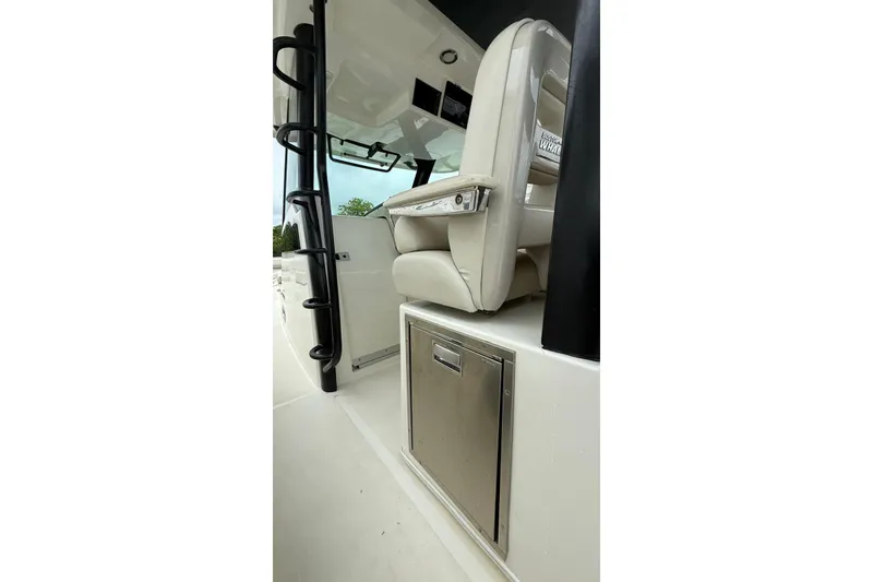 Slide: The Image of 2022 Boston Whaler 380 Outrage interior with seating and storage compartment. - 9
