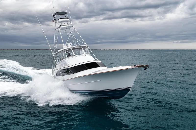Slide: The Image of Sportfishing yacht Merritt 58 (1997) cruising on open sea under cloudy skies. - 11