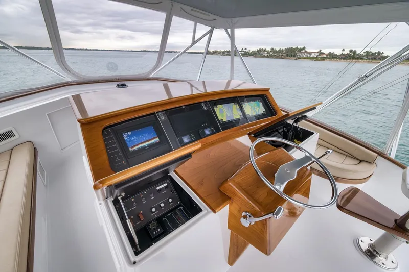 Slide: The Image of Helm of 1997 Merritt 58 yacht with modern navigation displays and wooden steering wheel. - 113