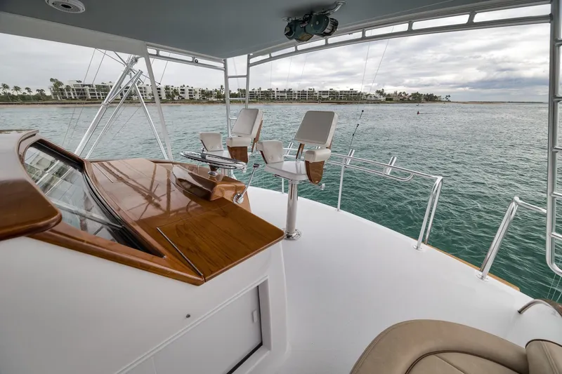 Slide: The Image of Luxury Merritt 58 yacht deck with ocean view, featuring elegant seating and polished wood accents. - 116