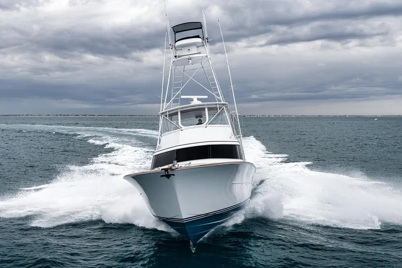 Slide: The Image of 1997 Merritt 58 yacht cruising on open sea under cloudy skies. - 12