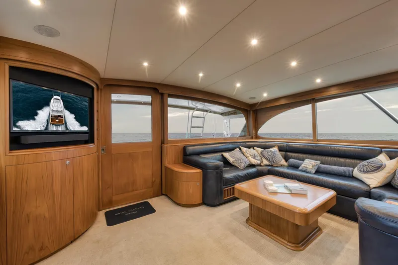 Slide: The Image of Luxurious Merritt 58 yacht interior, featuring elegant wood paneling and plush seating, 1997 model. - 121