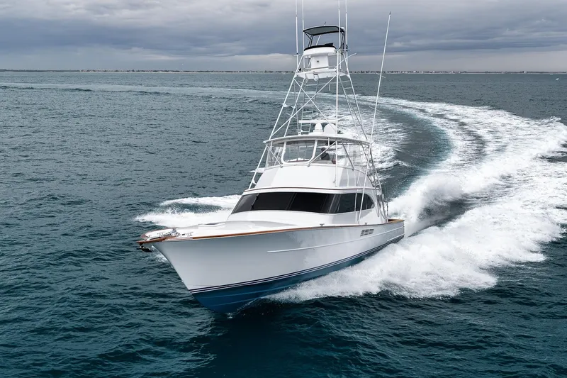 Slide: The Image of 1997 Merritt 58 yacht cruising swiftly on open ocean waters. - 13