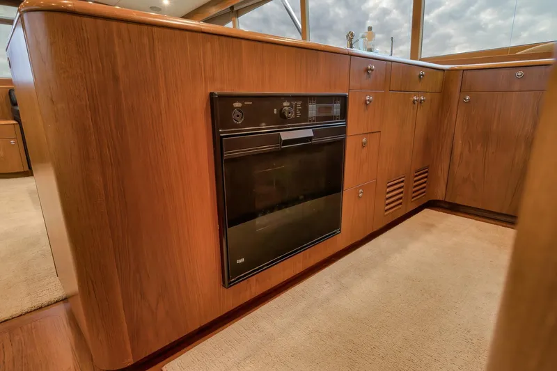 Slide: The Image of Luxurious Merritt 58 yacht kitchen with wood cabinetry and built-in oven, 1997 model. - 130