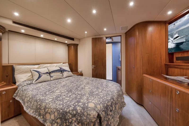 Slide: The Image of Luxurious 1997 Merritt 58 yacht bedroom with elegant wood finishes and cozy bedding. - 138