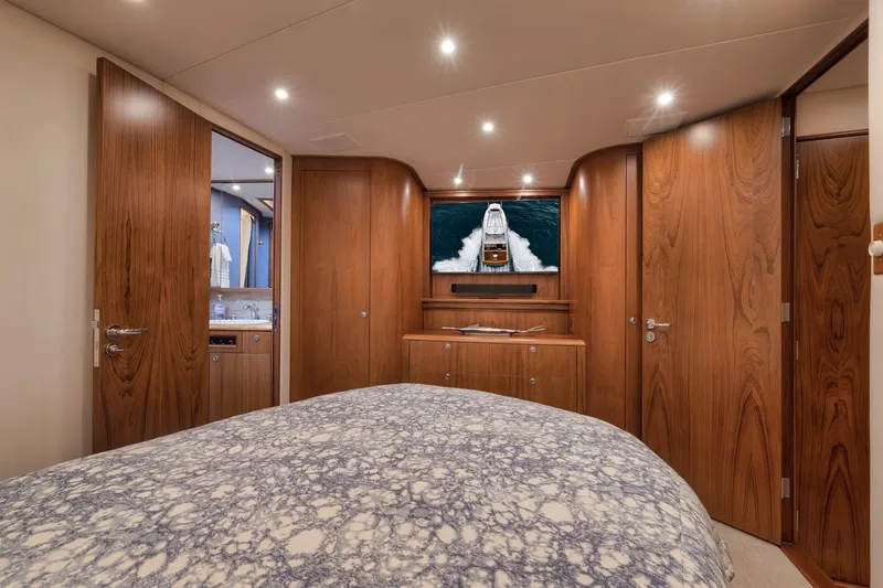 Slide: The Image of Luxurious cabin interior of a 1997 Merritt 58 yacht with wooden finishes and cozy bedding. - 139