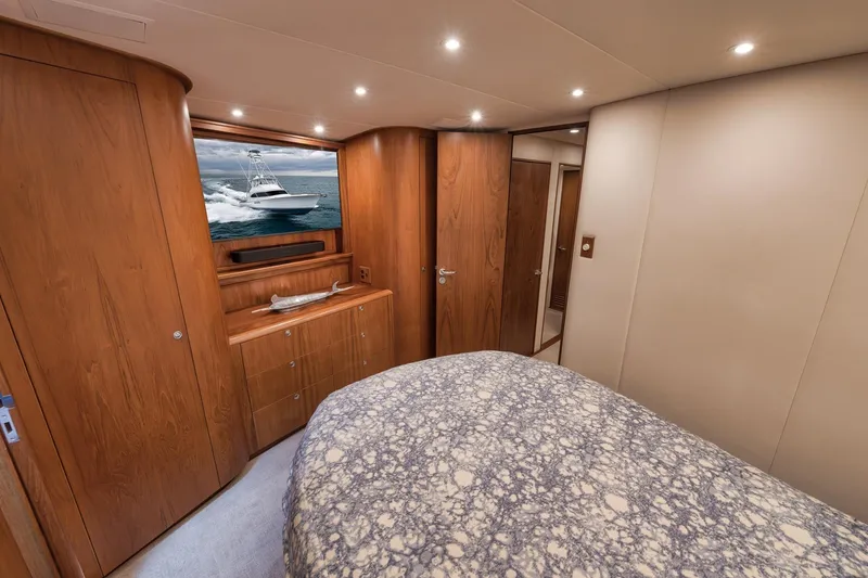 Slide: The Image of Luxurious cabin interior of 1997 Merritt 58 yacht with wood paneling and cozy bedding. - 140