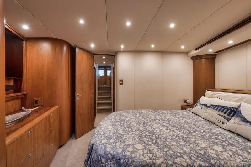 Slide: The Image of Luxurious bedroom interior on a 1997 Merritt 58 yacht, featuring elegant wood finishes. - 141