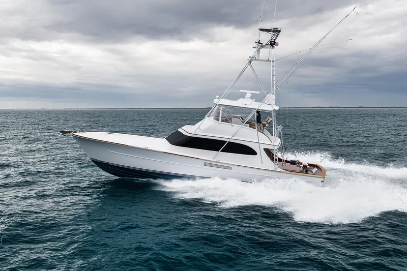 Slide: The Image of 1997 Merritt 58 yacht cruising on open ocean under cloudy skies. - 20