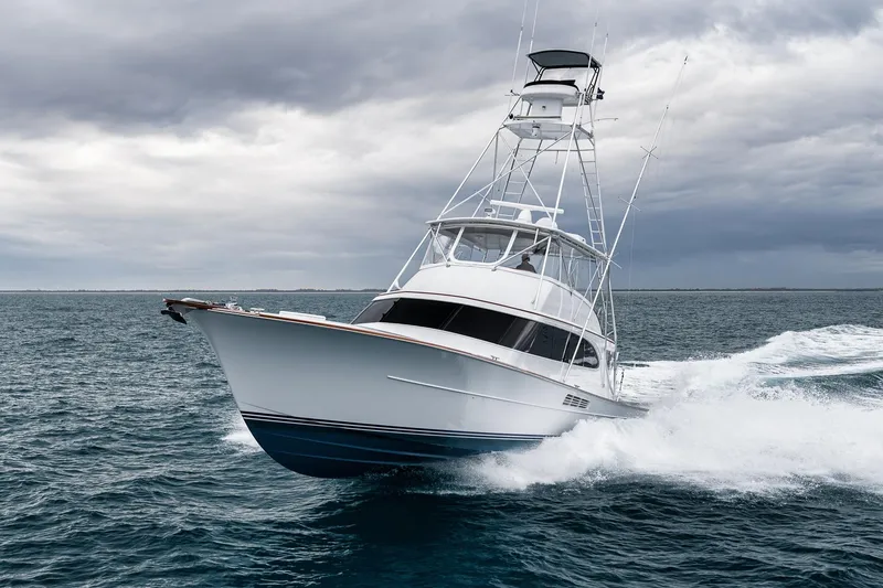 Slide: The Image of A 1997 Merritt 58 yacht cruising through choppy waters under a cloudy sky. - 22