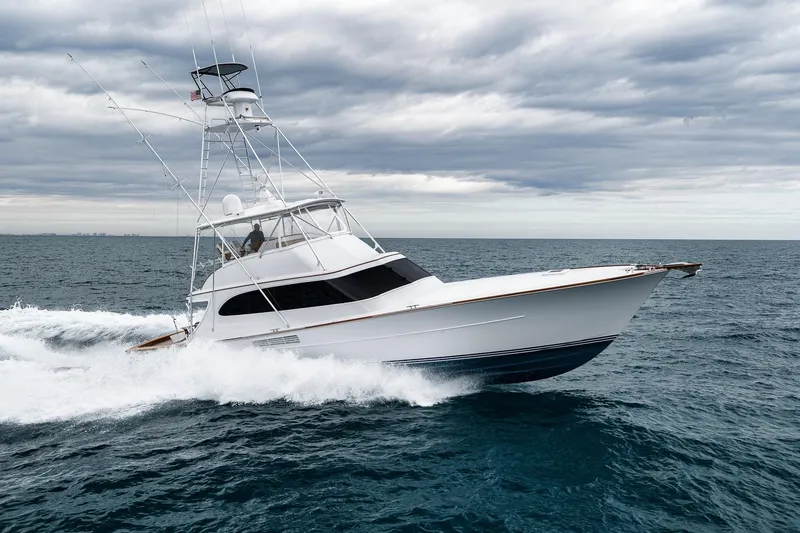 Slide: The Image of A 1997 Merritt 58 yacht cruising on the ocean under a cloudy sky. - 27