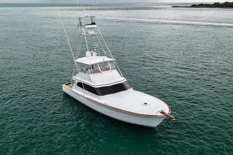 Slide: The Image of White 1997 Merritt 58 yacht cruising on calm ocean waters. - 38