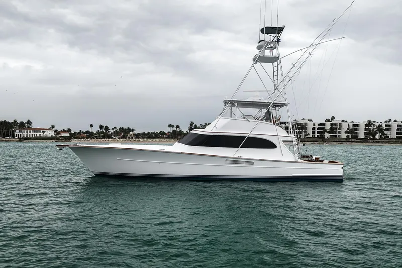 Slide: The Image of 1997 Merritt 58 yacht on calm waters with overcast sky and coastal backdrop. - 39