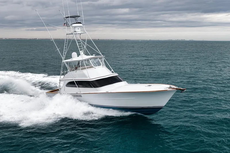 Slide: The Image of 1997 Merritt 58 yacht cruising on open sea under cloudy skies. - 4