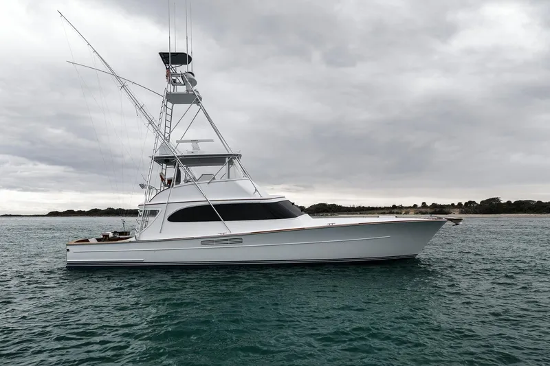 Slide: The Image of 1997 Merritt 58 yacht on calm waters under cloudy skies. - 41