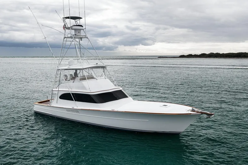 Slide: The Image of 1997 Merritt 58 yacht on calm waters under cloudy skies. - 43