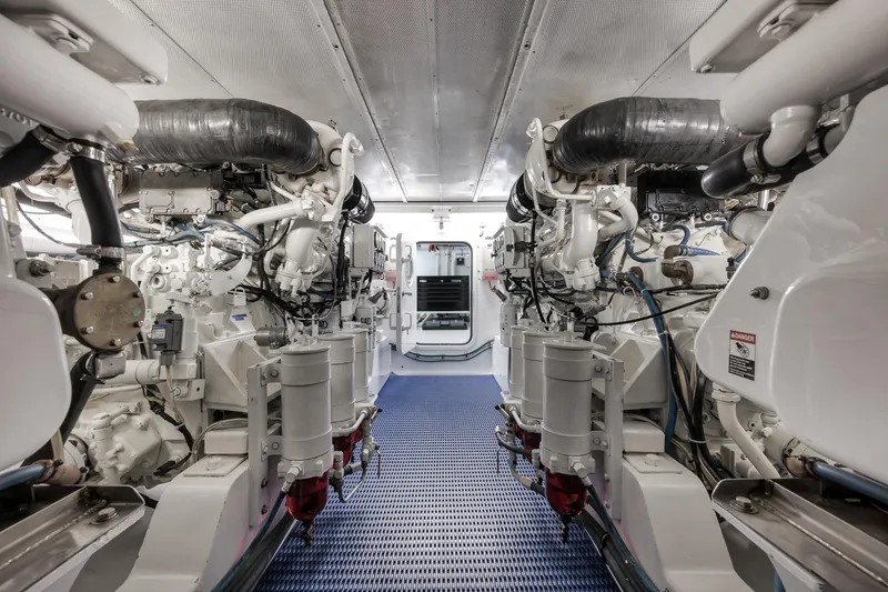 Slide: The Image of Engine room of a 1997 Merritt 58 yacht, showcasing dual engines and mechanical systems. - 54