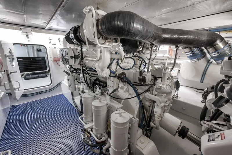 Slide: The Image of Engine room of 1997 Merritt 58 yacht, showcasing complex machinery and piping. - 55