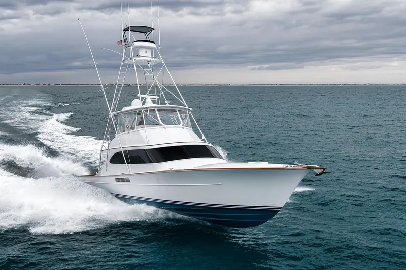 Slide: The Image of 1997 Merritt 58 yacht cruising on open sea under cloudy skies. - 6