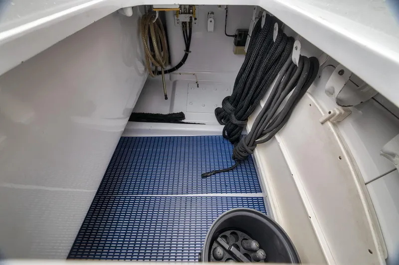 Slide: The Image of Storage compartment of a 1997 Merritt 58 boat with ropes and equipment. - 75
