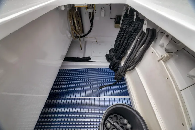Slide: The Image of Storage compartment of a 1997 Merritt 58 boat with ropes and equipment. - 76
