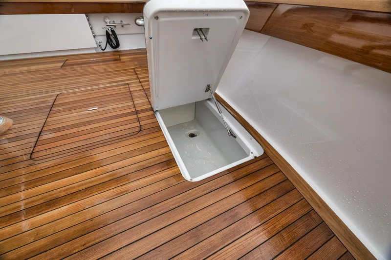 Slide: The Image of Open hatch on Merritt 58 boat deck, showcasing teak wood finish, 1997 model. - 80