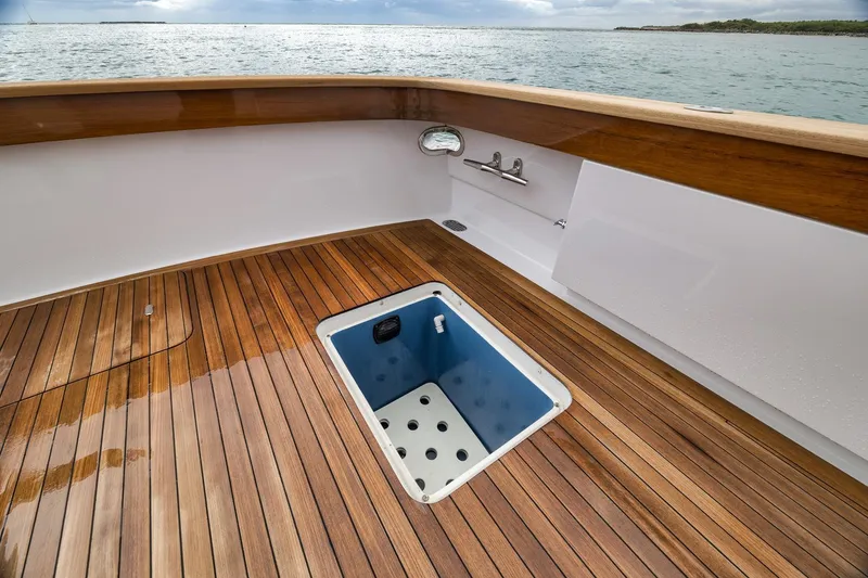 Slide: The Image of Teak deck of 1997 Merritt 58 yacht with open hatch, ocean view. - 81