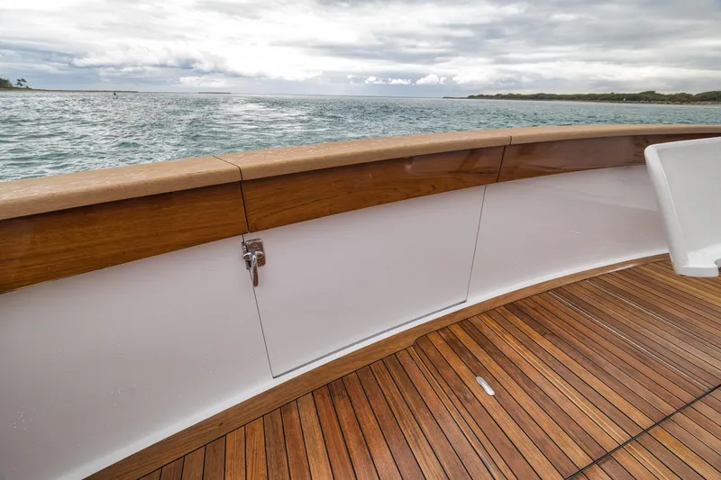 Slide: The Image of Wooden deck and railing of a 1997 Merritt 58 yacht overlooking the ocean. - 86