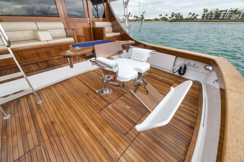 Slide: The Image of Luxurious 1997 Merritt 58 yacht deck with teak flooring and fishing chair. - 88