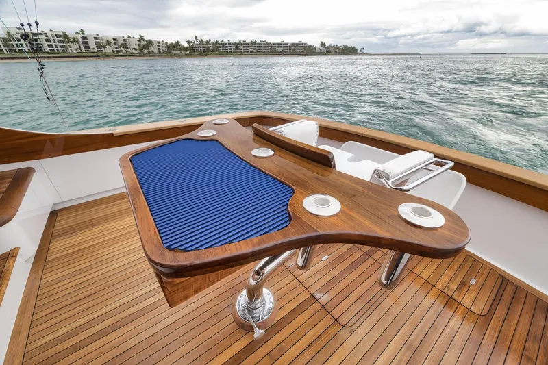 Slide: The Image of Luxury Merritt 58 yacht deck with wooden finish, ocean view, and fishing chair, 1997 model. - 89