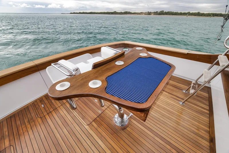 Slide: The Image of Luxury Merritt 58 yacht deck with wooden flooring and fishing chair, 1997 model. - 90