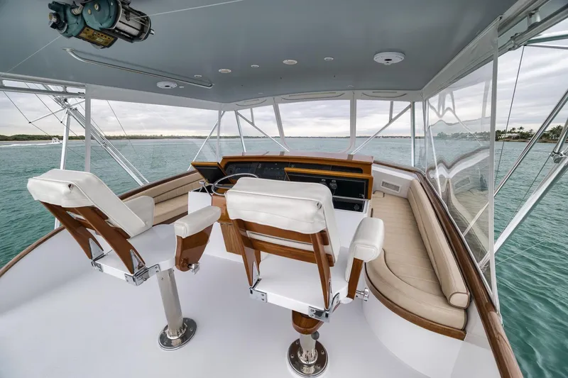 Slide: The Image of Cockpit view of 1997 Merritt 58 yacht with ocean backdrop and luxurious seating. - 99