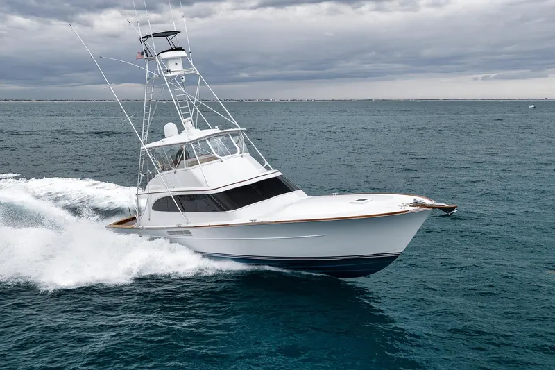 Slide: The Image of 1997 Merritt 58 yacht cruising on open sea under cloudy skies. - 10