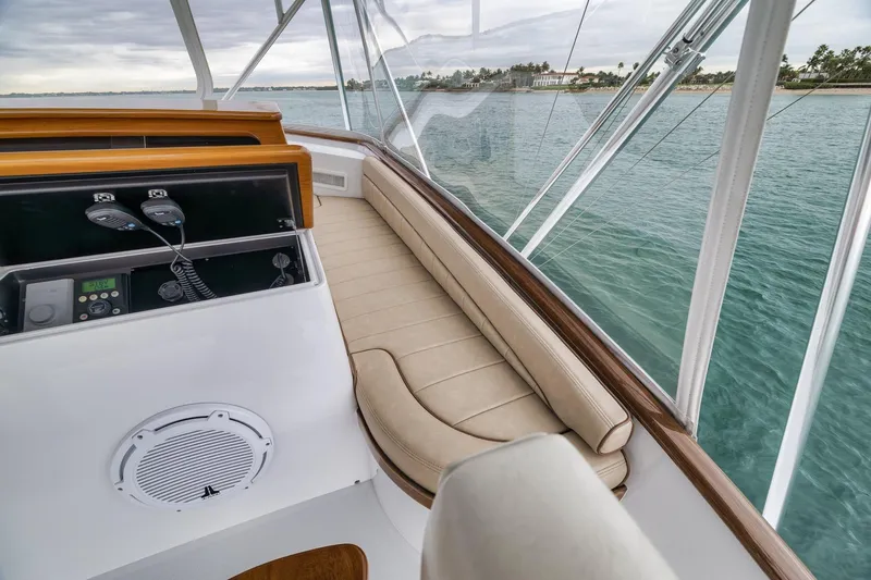 Slide: The Image of Cockpit view of 1997 Merritt 58 yacht with beige seating and ocean backdrop. - 102