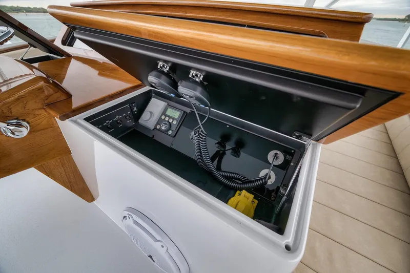 Slide: The Image of Control panel of a 1997 Merritt 58 yacht with wooden accents and electronic equipment. - 103