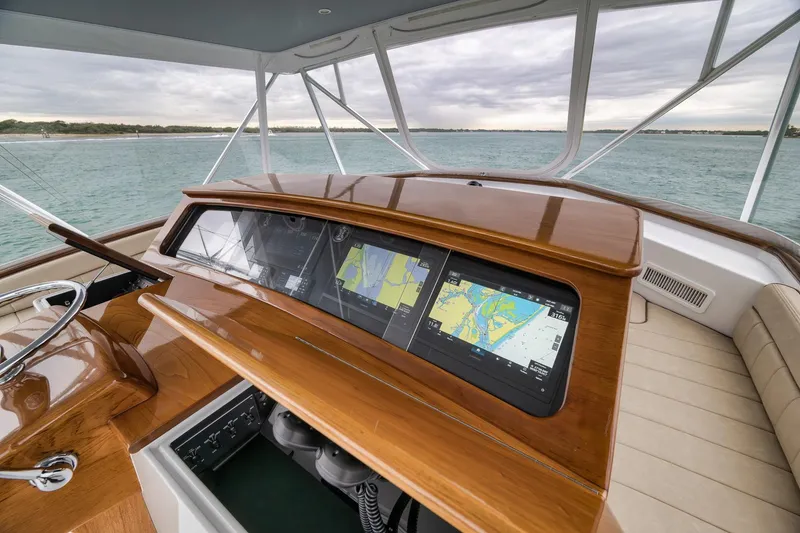 Slide: The Image of Luxurious 1997 Merritt 58 yacht helm with advanced navigation displays and polished wood finish. - 104
