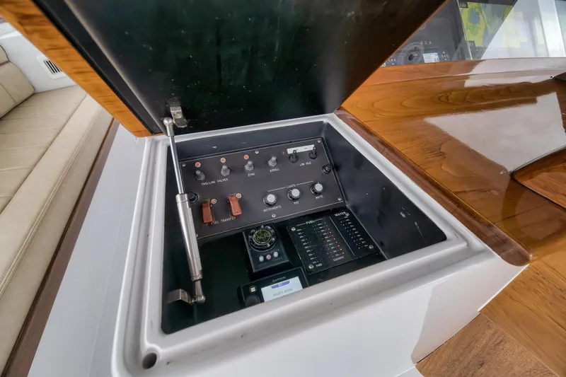 Slide: The Image of Control panel of a 1997 Merritt 58 yacht with various switches and gauges. - 111