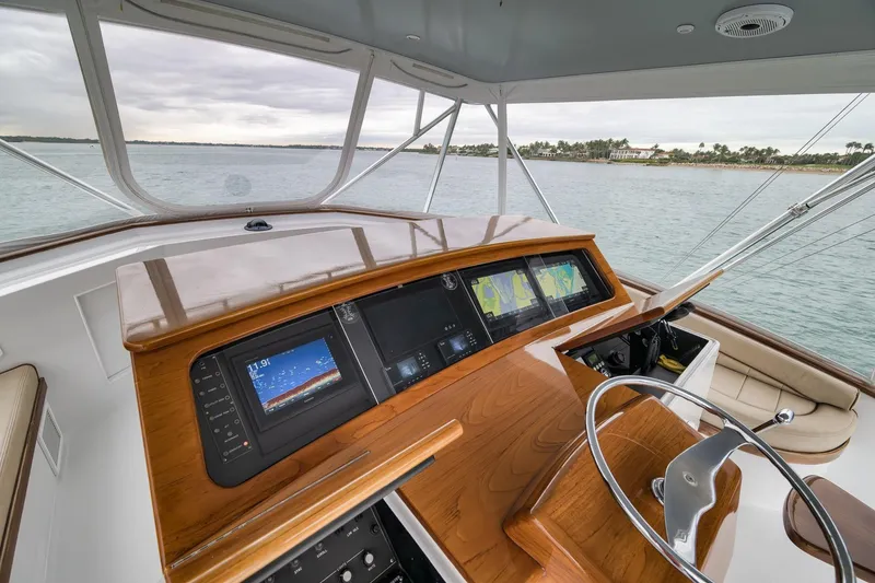 Slide: The Image of Helm of 1997 Merritt 58 yacht with navigation screens and wooden dashboard. - 114